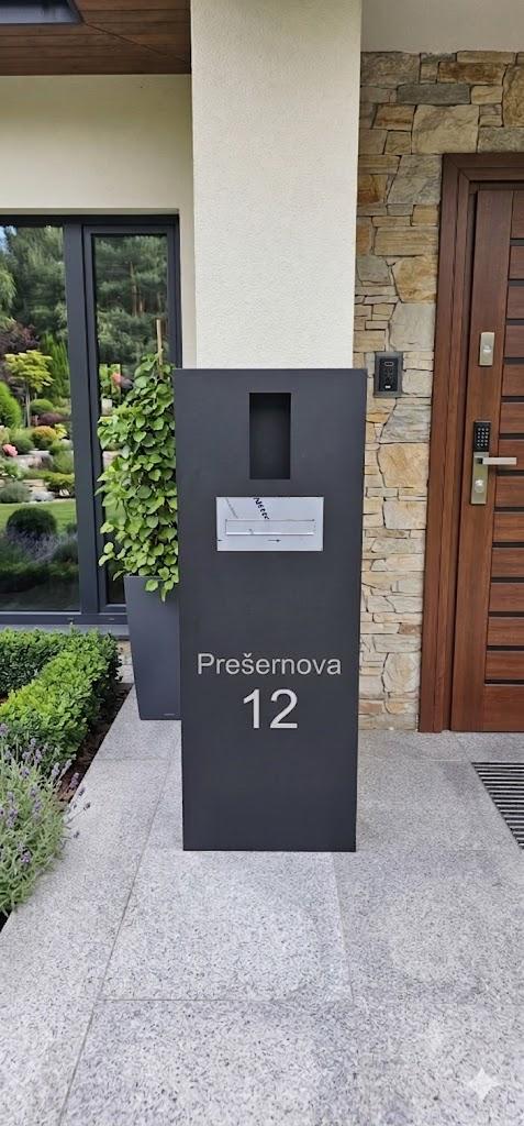 Antracitni multimedijski steber z gravirano hišno številko pred vhodom